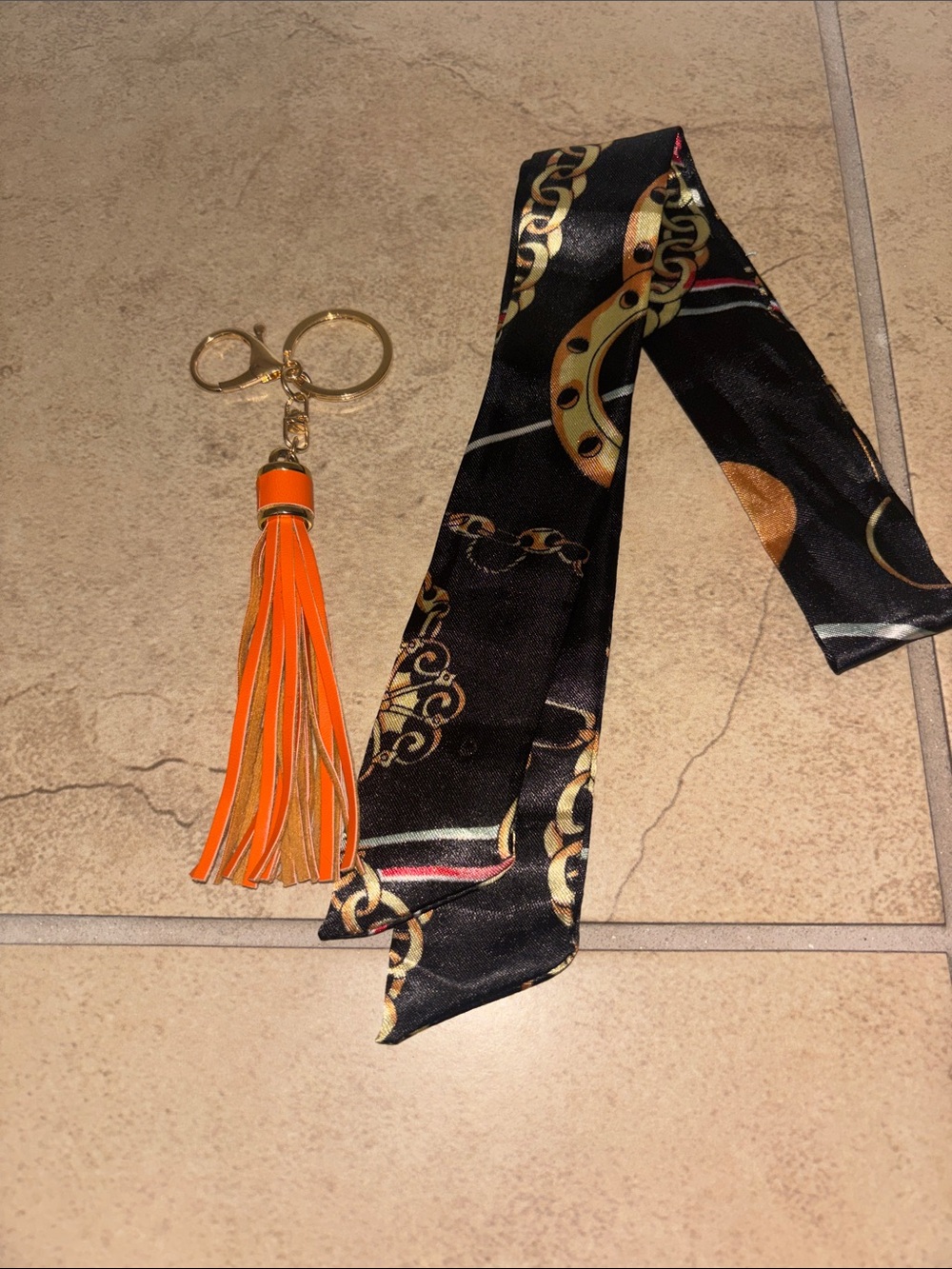 Orange Tassel Keychain with Black Chain-Print Scarf Accent